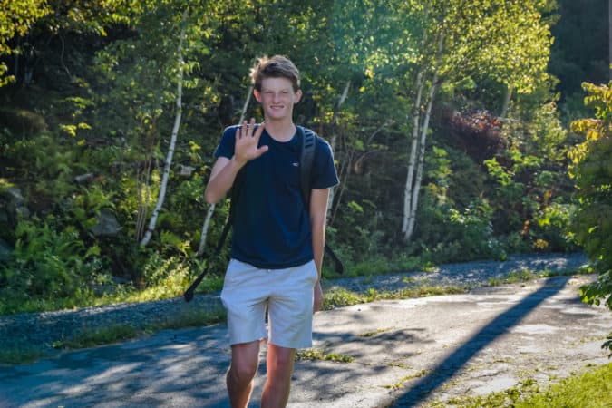 teen boy waving