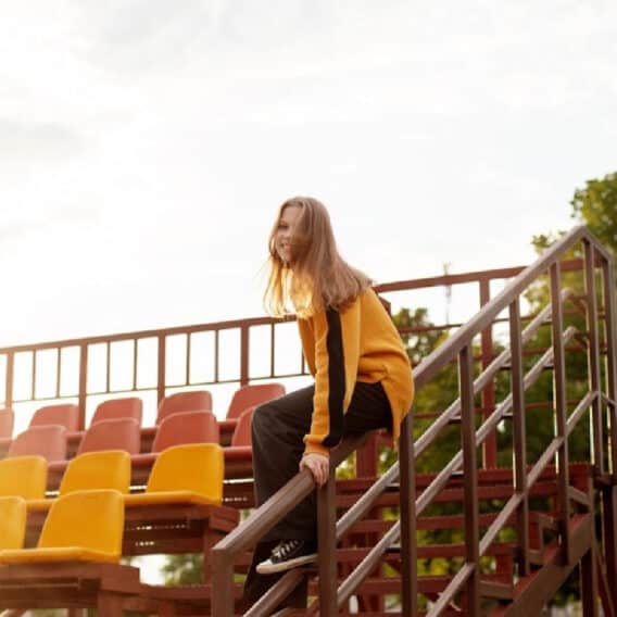 Teen on bleachers