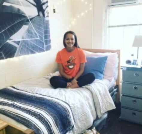 Girls sititng on bed in dorm