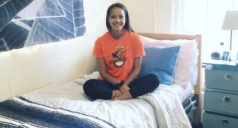 Girls sititng on bed in dorm