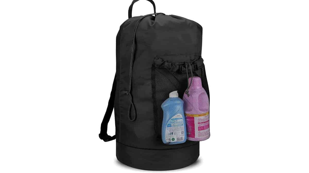 A black Dalykate Laundry Backpack holding laundry soap in the outer pocket. 